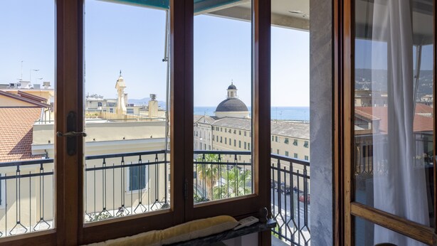 A balcony with a view of city buildings and a dome structure. - JOIVY Front Sea Apt With Big Terrace In Chiavari (Chiavari)