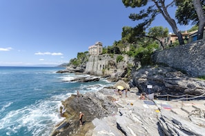 A coastal building with a stone facade, situated on a rocky cliff overlooking the sea. - JOIVY Villa W/Superb View And Private Garden In Mulinetti (Recco)