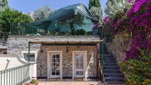 A stone building with two doors, a staircase, and a green canopy. - JOIVY Villa W/Superb View And Private Garden In Mulinetti (Recco)