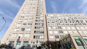 A tall, beige building with multiple windows and a sign that reads "INTESA." - JOIVY Lovely Apt On The Historical Street Via Cantore (Genoa)