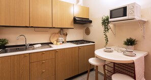Enjoy cooking in this well-equipped kitchen with a microwave, sink, and stove.