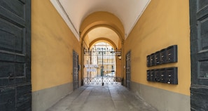 Corridors feature black mailboxes mounted on the wall, flanked by large doors.