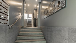 A staircase with metal railings and a wall-mounted picture.