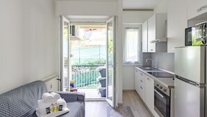 A compact kitchen with a built-in oven and a microwave.