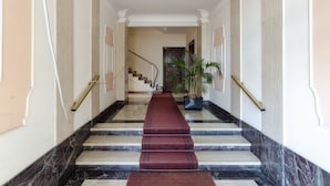 A marble staircase with a red carpet leading to a door at the top. - JOIVY Great Flat W/Sea View (Genoa)