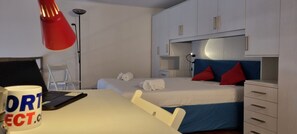 Studio | Desk, laptop workspace, blackout drapes, iron/ironing board