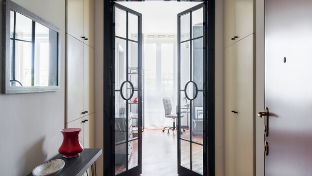 A hallway with a glass door leading to a room with a desk and chair. - JOIVY Superb Flat W/Home Office (Milan)
