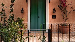 A building with a green door, a white awning, and a sign that reads "Furnace."
