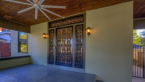 A covered entrance with a wooden ceiling and a decorative door with glass panels. - Funky Memphis Game House! FirePit, Gtd pkg, Games! (Memphis)