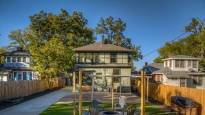 A backyard with a covered patio area, outdoor seating, and a fire pit. - Funky Memphis Game House! FirePit, Gtd pkg, Games! (Memphis)