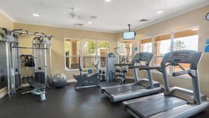 A gym with treadmills, elliptical machines, and weight equipment.
