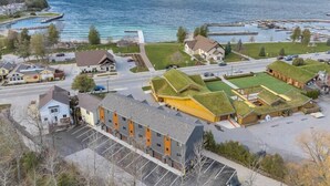 A coastal town with buildings, a marina, and a road leading to the water.