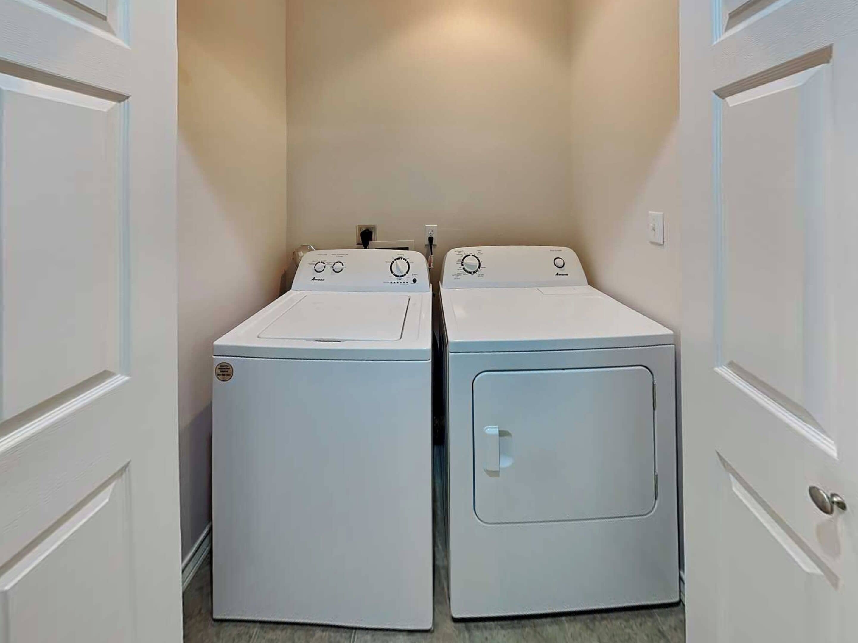 A laundry room with two front-loading washing machines.