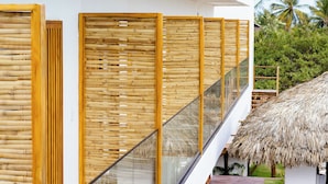 A modern building with a staircase, bamboo partitions, and a thatched roof structure. - Mikiki Lifestyle Hotel (Cajueiro da Praia)