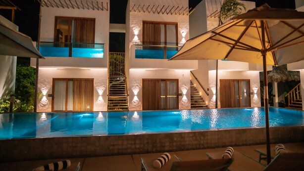 A modern hotel with a swimming pool, multiple balconies, and outdoor seating areas. - Mikiki Lifestyle Hotel (Cajueiro da Praia)