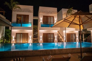 A modern hotel with a swimming pool, multiple balconies, and outdoor seating areas. - Mikiki Lifestyle Hotel (Cajueiro da Praia)