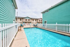 Relax by the pool surrounded by comfortable lounge chairs and picturesque views.