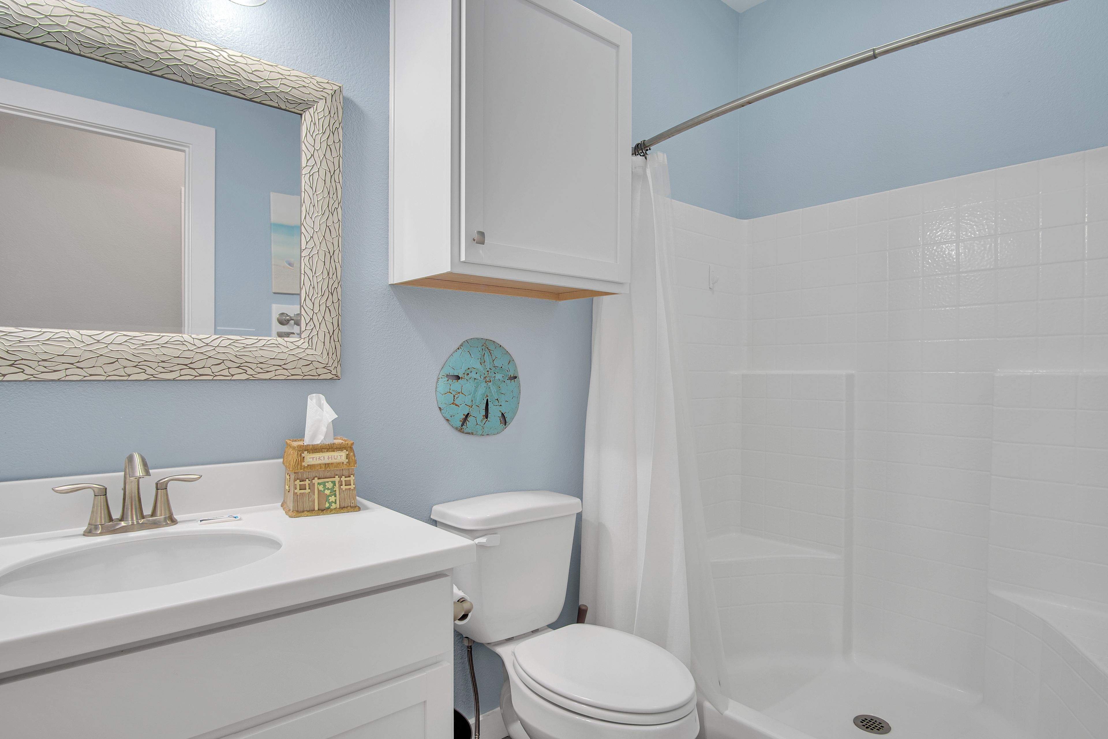 A bathroom with a sink, toilet, and shower.