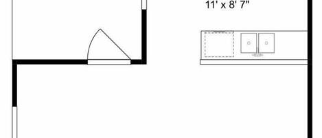 A floor plan with a balcony, kitchen, family room, bedroom, half bath, closet, and bath.