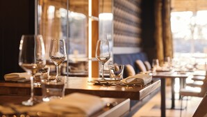 A restaurant interior with tables set for dining, glasses, and cutlery. - Safari Hotel Beekse Bergen (Hilvarenbeek)