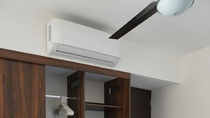A bedroom with a wardrobe, a bed, and an air conditioning unit. - CONDO LOMA by TRVL2HM (Nuevo Nayarit)