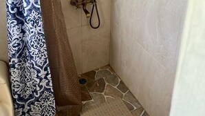 A shower with a handheld showerhead and a handheld hose. - Sea Breeze Studio At Carib Resort (Ocho Rios)