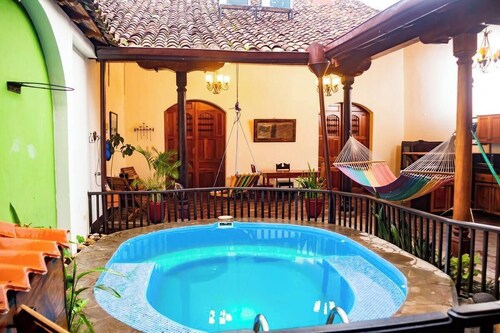 You’ll know that you have rented a historic colonial home when you pass through huge, antique front doors framed by 3 foot-thick adobe walls. Lounge on the shallow, submerged bench seats in the pool or in the hammocks hanging between 12 foot wooden c