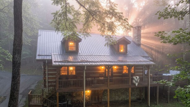 A rustic cabin with a porch, two windows, and a stone chimney. - Hounds Retreat Pet Friendly, Wood Fireplace, HotTub, WiFi, Decks (Ferguson)