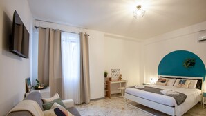 A modern bedroom with a bed, a desk, and a sofa. - [Central Station ★★★★★] Elegant Apartment (BARI)