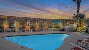 A backyard with a swimming pool, outdoor seating, and a hot tub. - LaJuana Iguana by Silver Sands Vacation Rentals (Port Aransas)