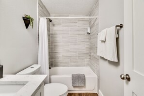 Combined shower/tub, hair dryer, towels, soap