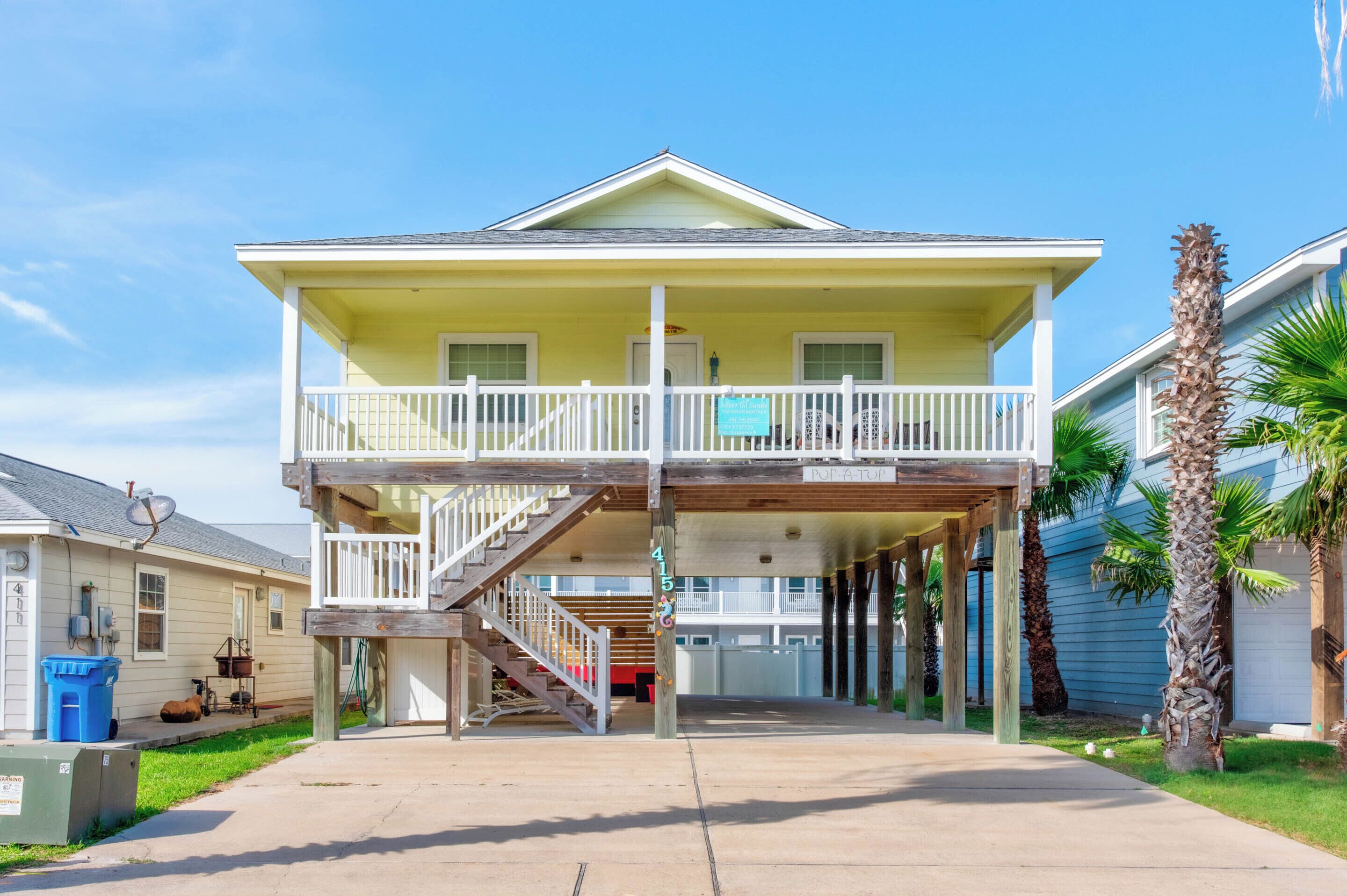A two-story house with a balcony, a staircase leading to the upper floor, and a garage.