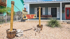 A rustic building with a sign reading "GOLF CART CORRAL" and a wooden fence. - Port A Ponderosa by Silver Sands Vacation Rentals (Port Aransas)