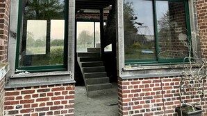 A two-story building with large windows, a visible staircase, and a brick exterior. - Appartement Type Loft en Pleine Nature (Rumigny)