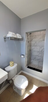 Family Room, 2 Bedrooms, Non Smoking | Bathroom | Shower, hydromassage showerhead, towels, soap at Travelers Inn