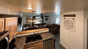 A modern kitchen with granite countertops, a built-in sink, and wooden cabinets. - New cute clean 4plex w/game rm, centrally located between North Pole & Fairbanks (Fairbanks)
