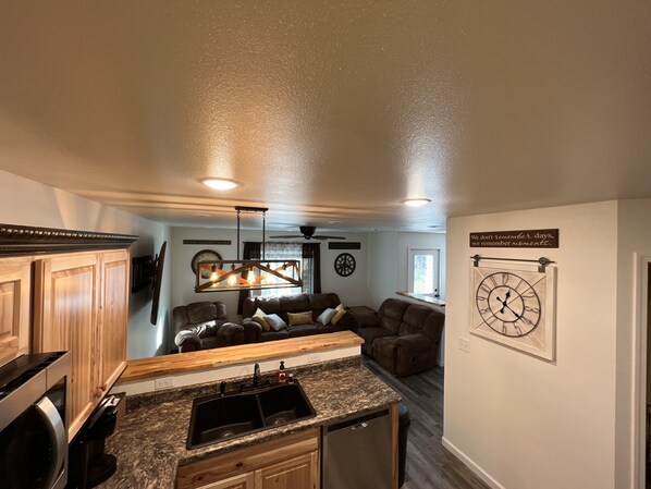 A modern kitchen with granite countertops, a built-in dishwasher, and a pendant light fixture. - New cute clean 4plex w/game rm, centrally located between North Pole & Fairbanks (Fairbanks)