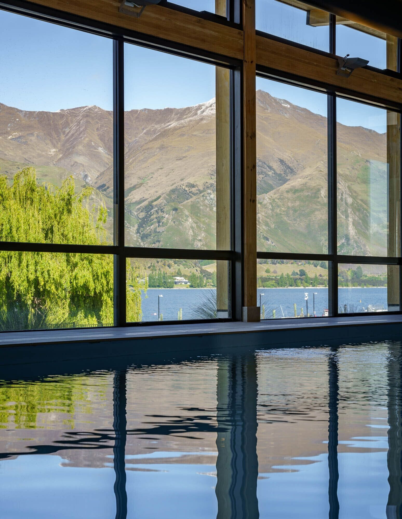 A pool with a view of mountains and a lake.