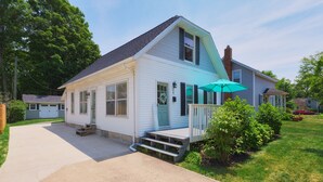 A two-story house with a front porch, a covered entryway, and a visible front door.