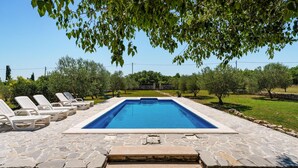 A rectangular swimming pool with stone steps leading up to it, surrounded by a stone deck. - Gorgeous home in Donji Kasic (Donji Kasic)