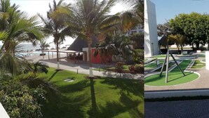 Zona de piscina con palmeras, un área de descanso cubierta y un jardín paisajístico con diseño geométrico.