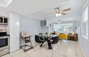 Enjoy meals at the glass table surrounded by comfortable chairs in this well-appointed space.