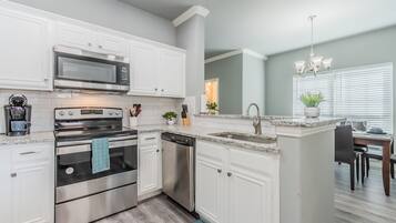 Superior Townhome | Private kitchen | Coffee/tea maker, dining tables