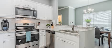 Superior Townhome | Private kitchen | Coffee/tea maker, dining tables