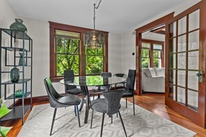 Enjoy meals in this cozy dining area with a round table and six chairs, surrounded by lush views and decorative accents.