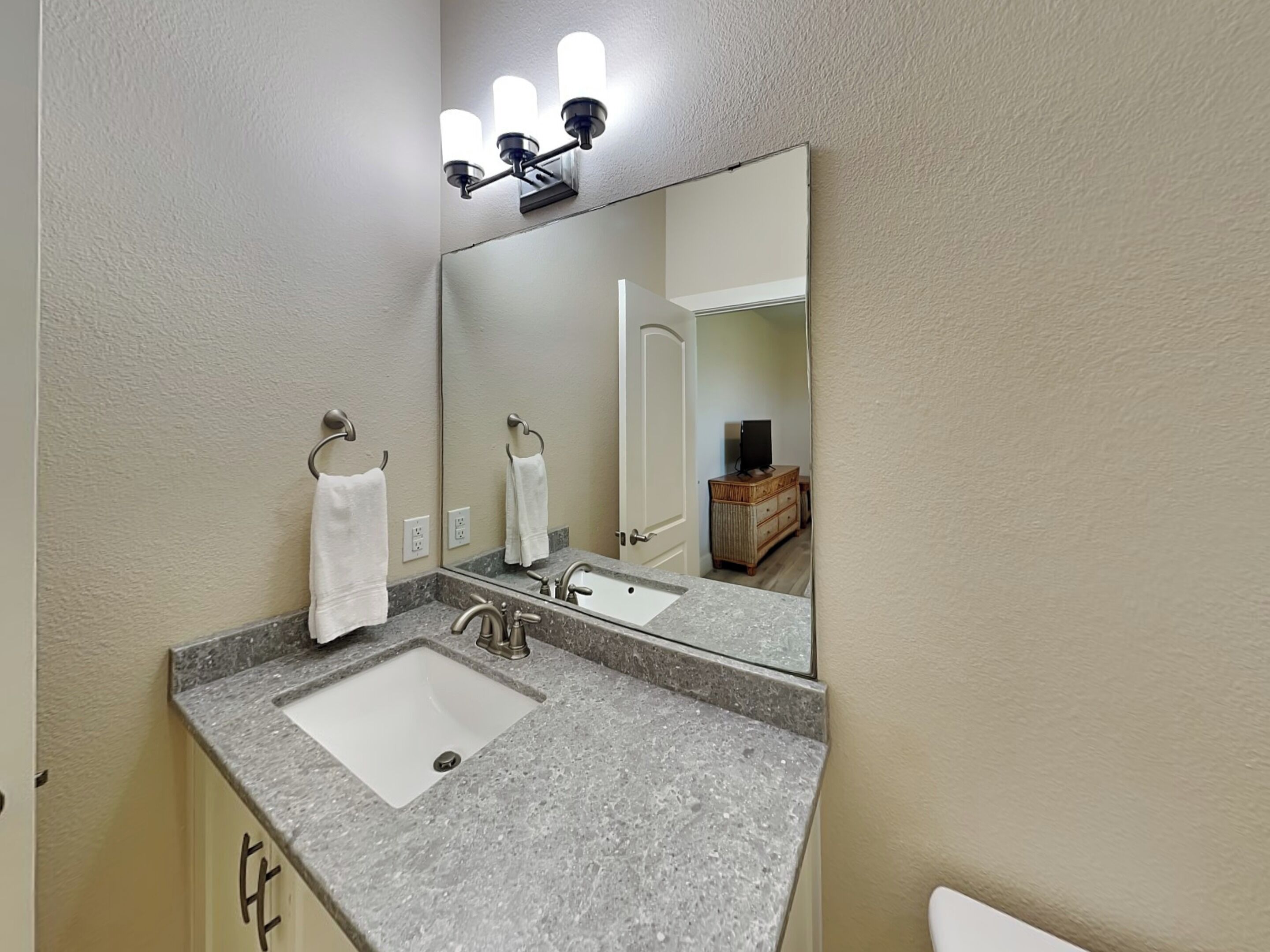A bathroom with a double sink, a mirror, and a vanity.
