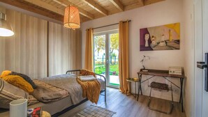 A cozy room with a bed, a desk, and a window with curtains. - Cozy Home in Rudzienice (Rudzienice)