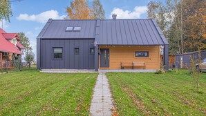A modern two-story house with a grey roof and wooden accents. - Cozy Home in Rudzienice (Rudzienice)