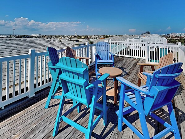Relax on the ocean-view deck with Adirondack chairs and a small table.