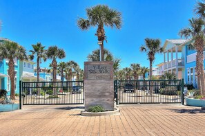 Enter Village Walk, a charming residential area with pedestrian-friendly walkways and beautiful palm trees.